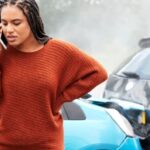 Woman in a car accident calling for help.